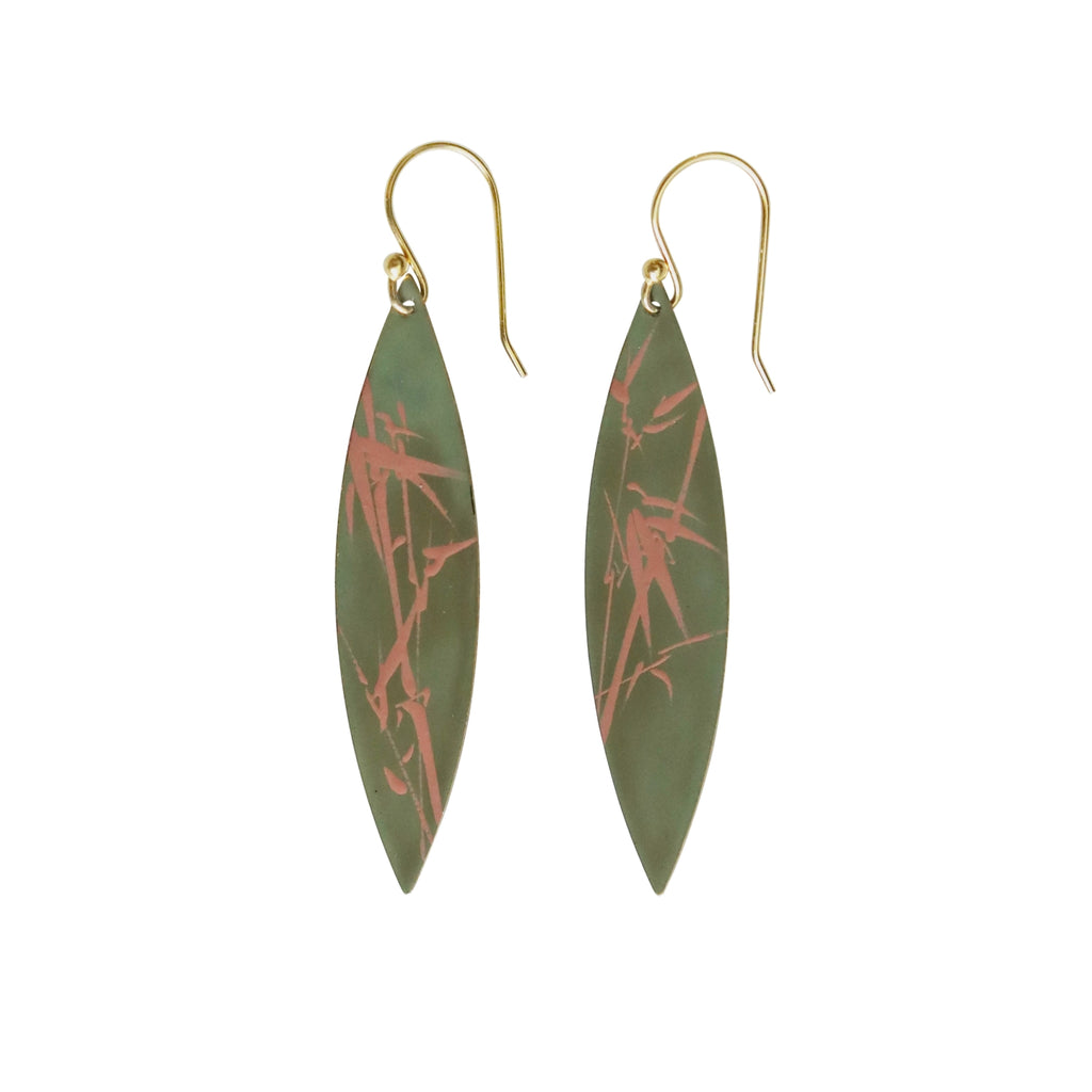Green earrings with red abstract design on a white background