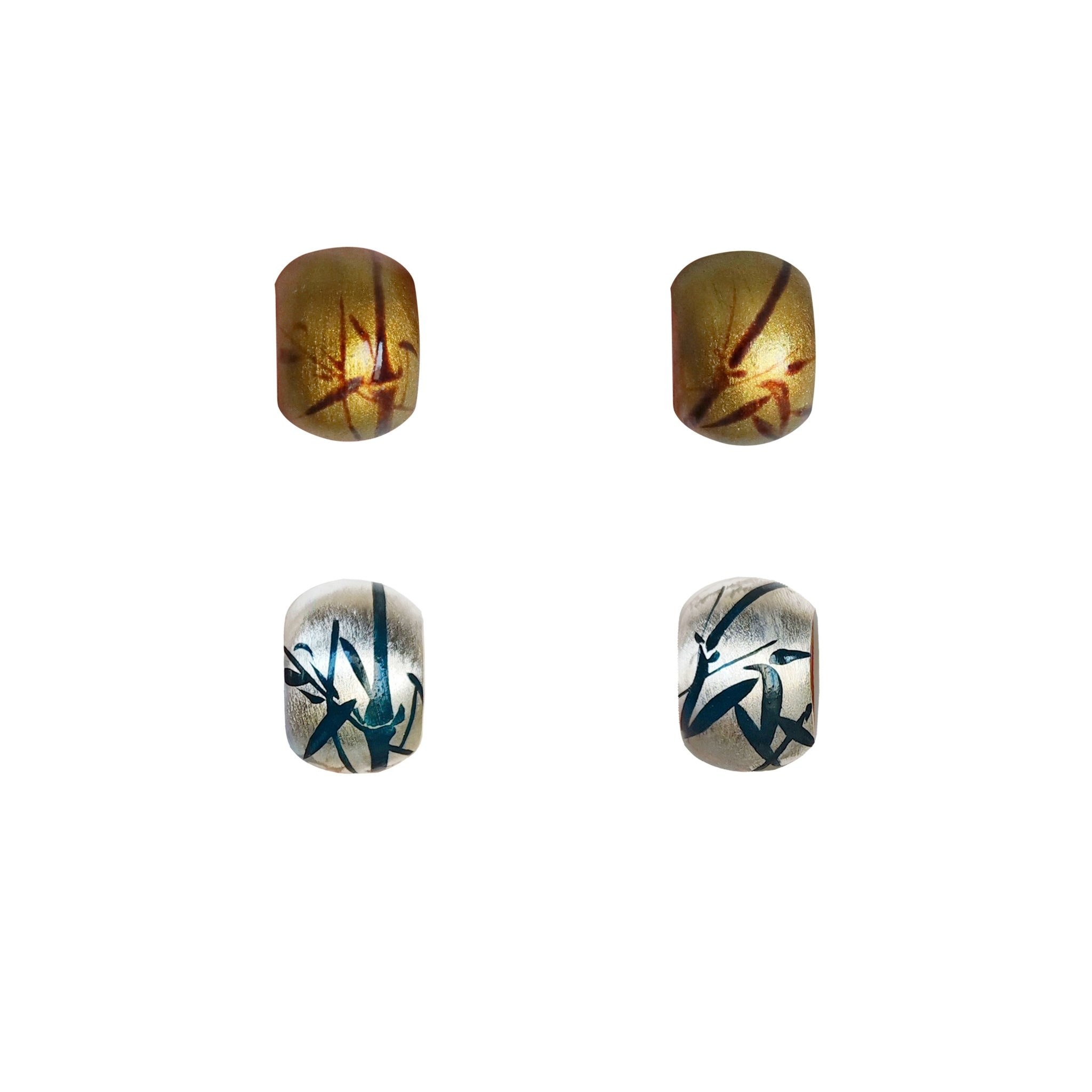 Four decorative beads with unique patterns on a white background