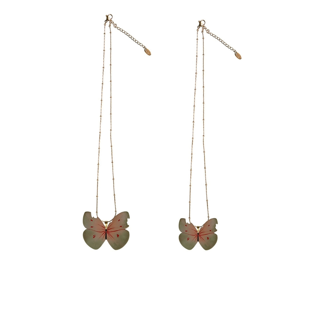 Butterfly-shaped earrings on gold chains against a white background