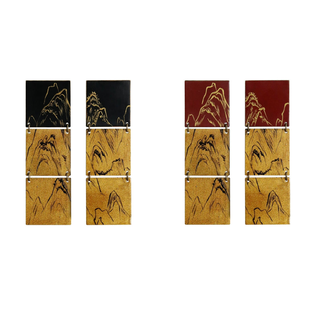 Set of four wooden panels with mountain designs on a white background
