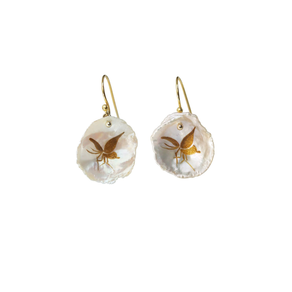 Pair of earrings with gold accents on a white background