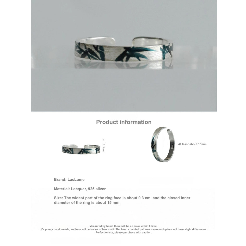 Silver ring with floral design on a gray background