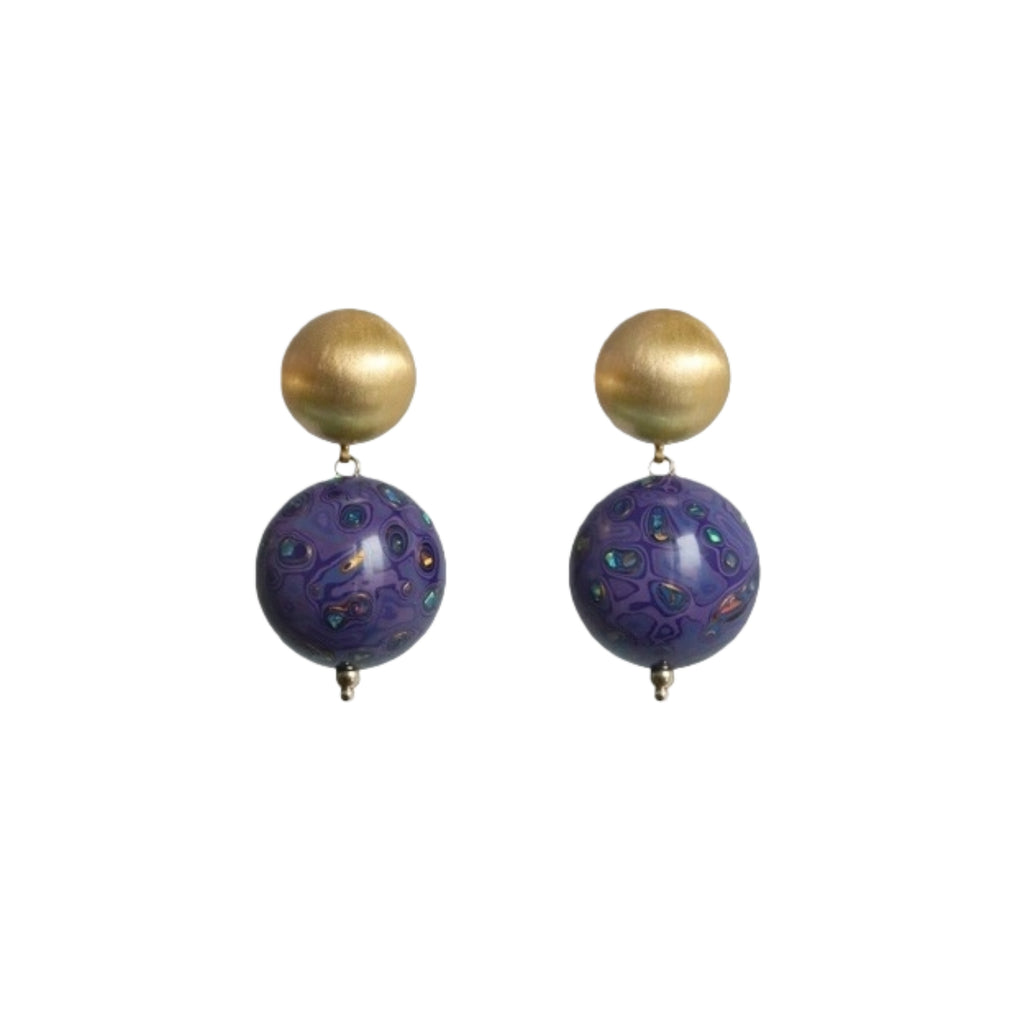 Pair of earrings with gold and purple beads on a white background