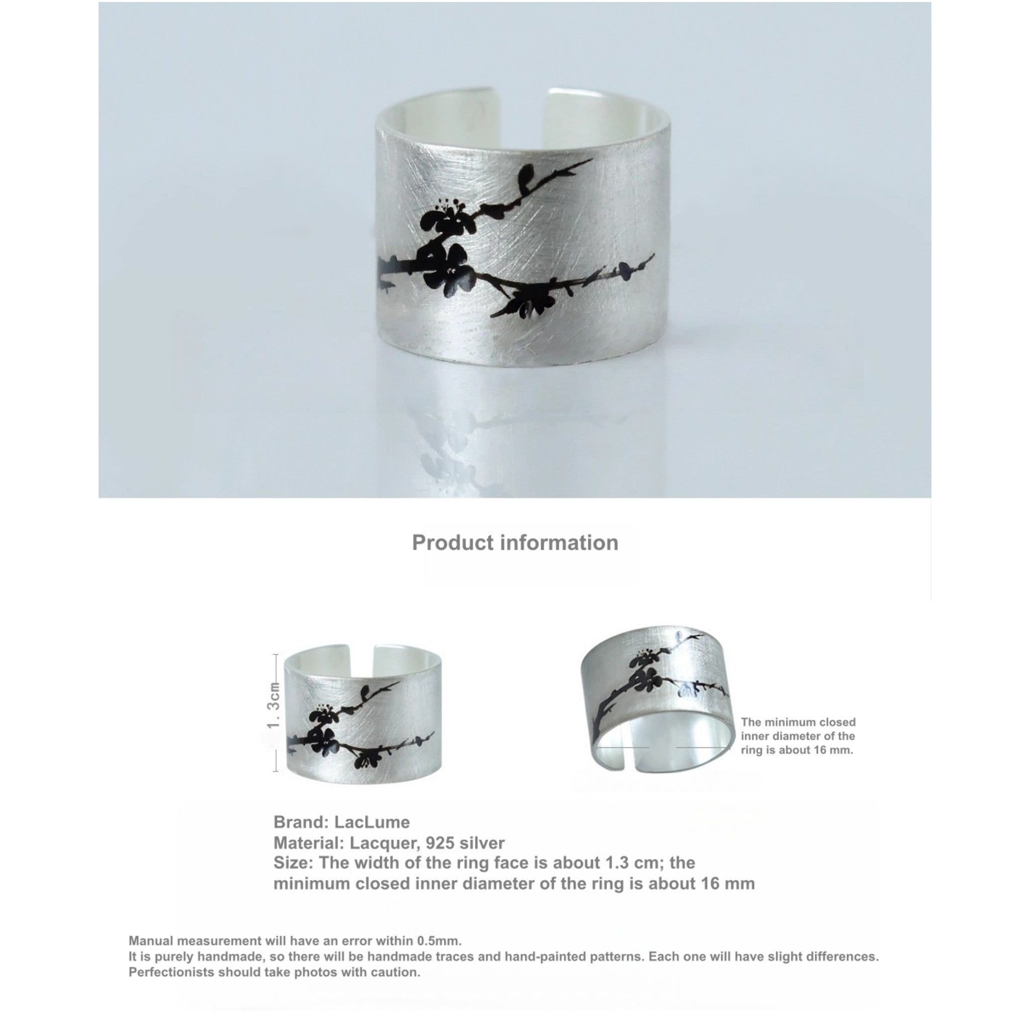 Silver cuff bracelet with black floral design on a light gray background