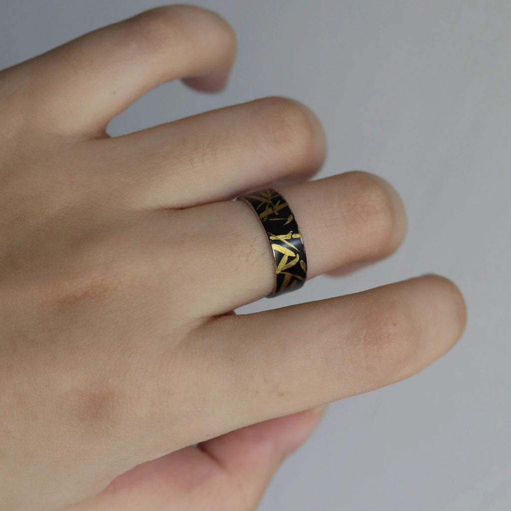 Hand wearing a ring with intricate design on a plain background LacLume HandPainted Lacquer Silver Ring Bamboo Pattern Handmade Silver Lacquerware
