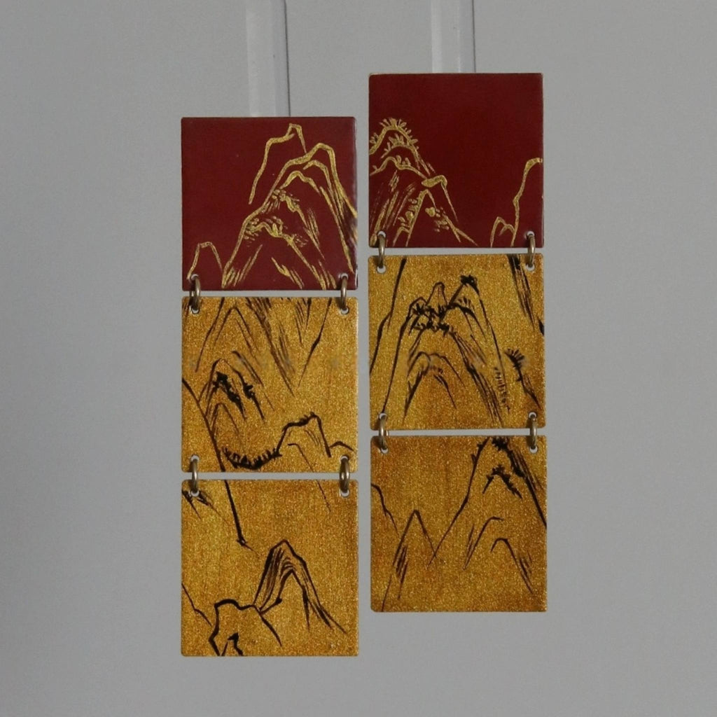 Set of five rectangular tiles with mountain designs on a gray background