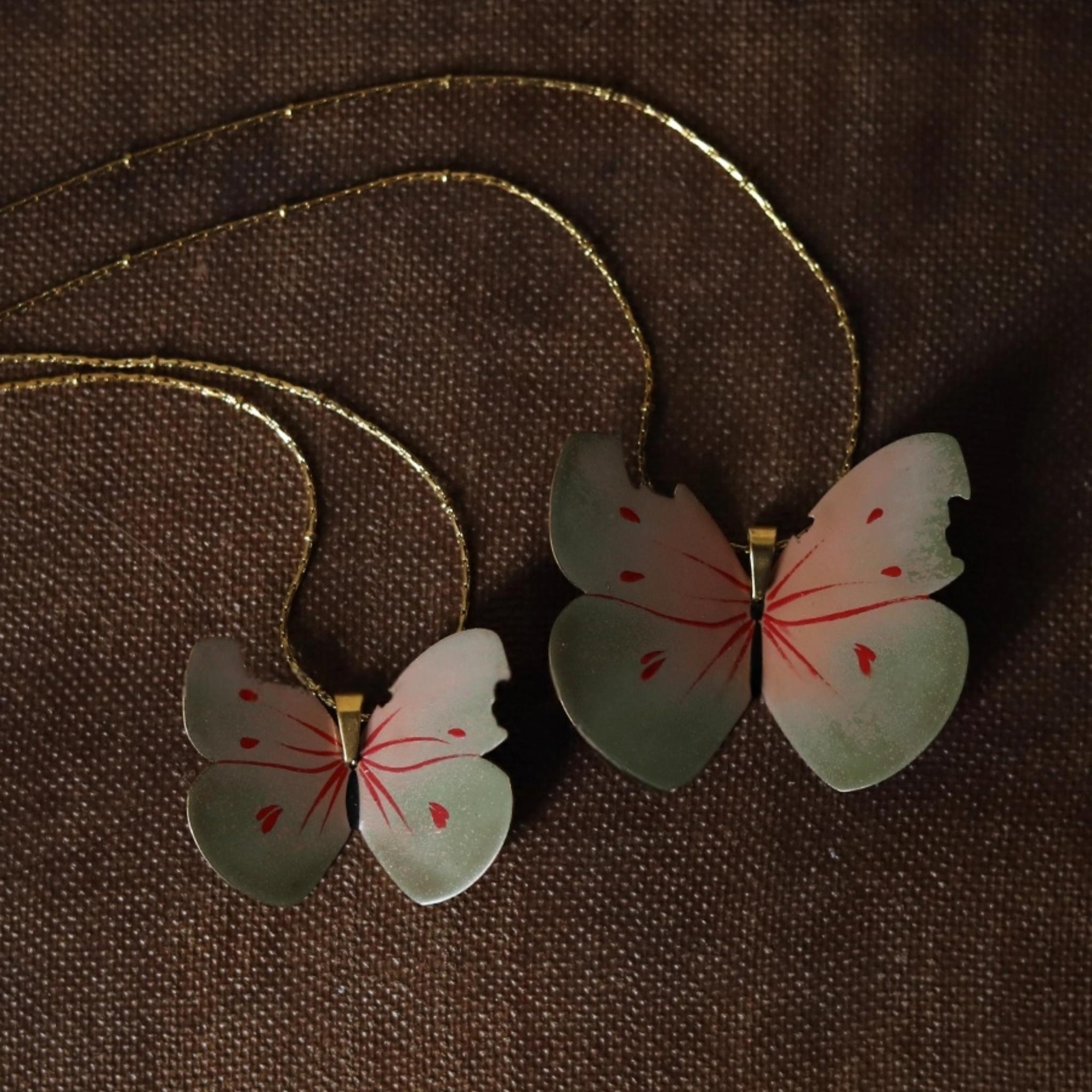 Butterfly-shaped earrings on a brown textured background
