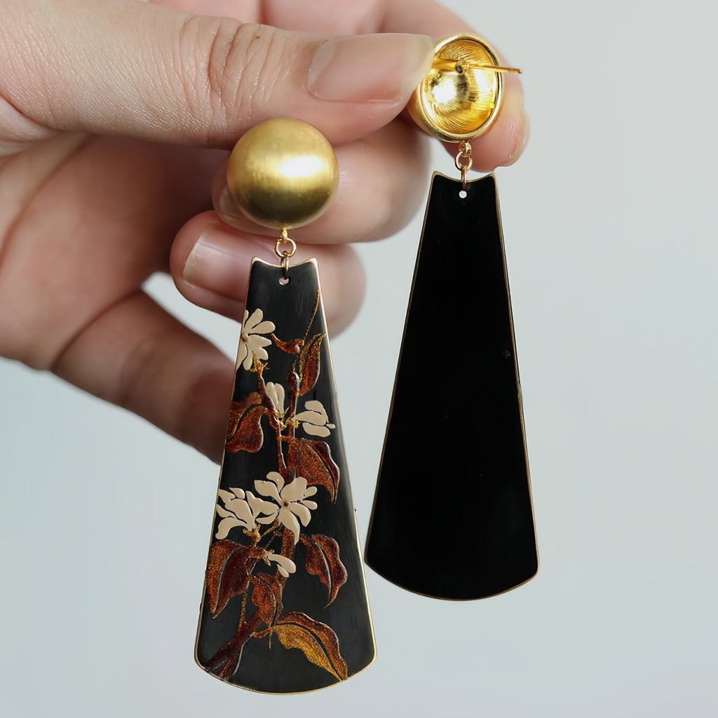 Black earrings with floral design held by a hand against a light background LacLume Earrings Summer Jasmine Plant Pattern Jewelry Handmade Lacquer Jewelry