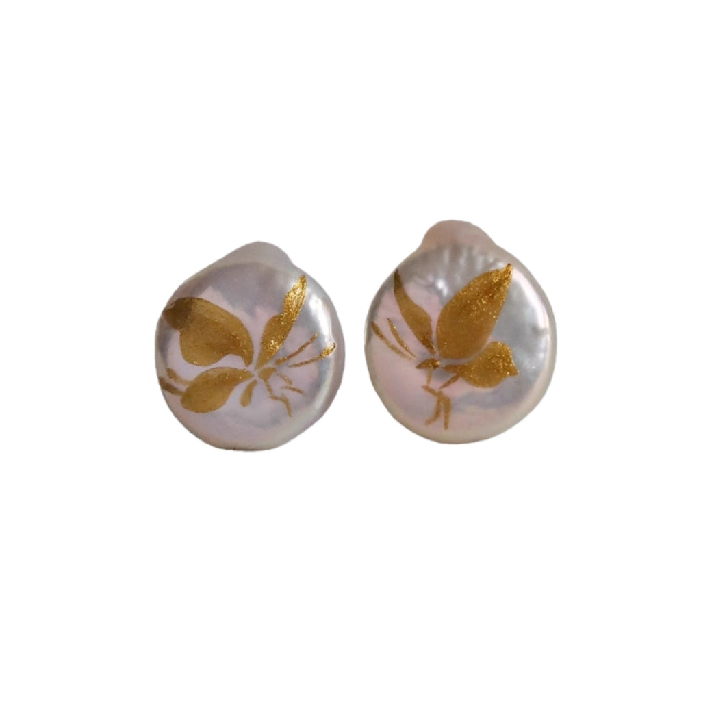 Pair of earrings with gold leaf design on a white background