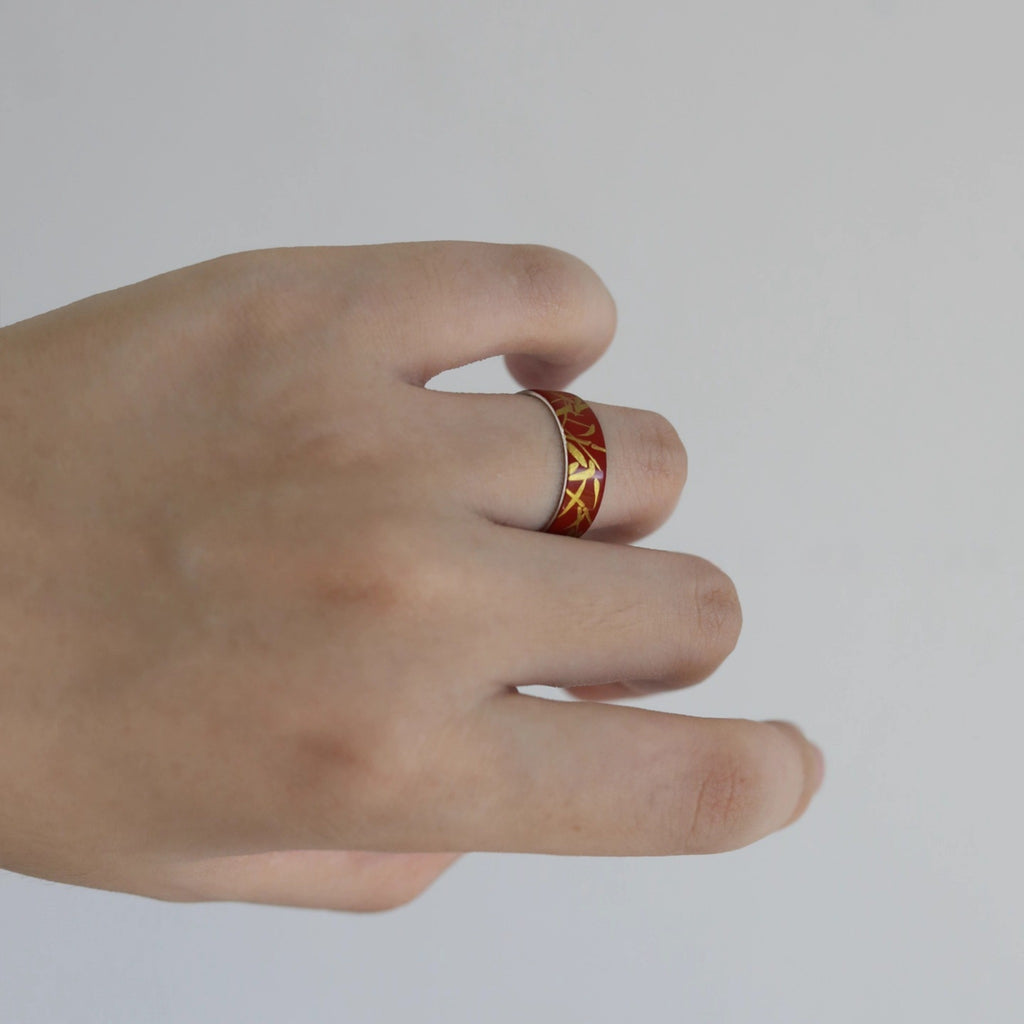 Hand wearing a ring with intricate design on a plain background LacLume HandPainted Lacquer Silver Ring Bamboo Pattern Handmade Silver Lacquerware