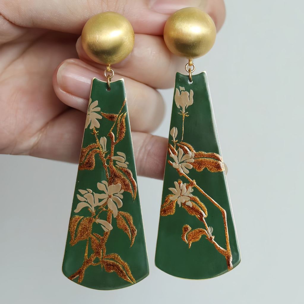 Green earrings with floral patterns held by a hand against a neutral background LacLume Earrings Summer Jasmine Plant Pattern Jewelry Handmade Lacquer Jewelry