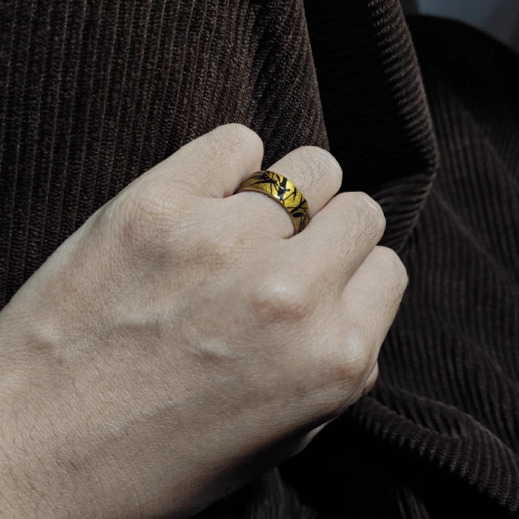 Hand wearing a gold ring with a dark background LacLume HandPainted Lacquer Silver Ring Bamboo Pattern Handmade Silver Lacquerware