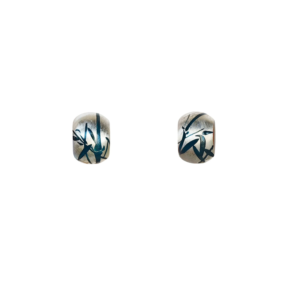 Pair of earrings with black and blue designs on a white background
