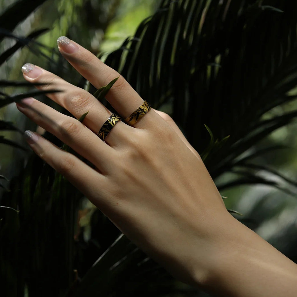 Hand with a ring on a background of green foliage LacLume HandPainted Lacquer Silver Ring Bamboo Pattern Handmade Silver Lacquerware